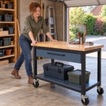 Woman pushing the mobile workbench across the garage floor