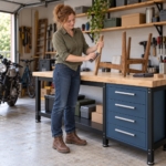 Woman sanding a wooden chair leg on the long heavy-duty workbench