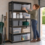Woman lifting a clear storage box onto the fourth shelf of the steel shelving unit