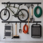 Front view of the wall rail system with garden tools and folding chairs