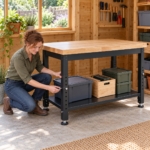 Woman adjusting the height of the workbench leg with its locking pin