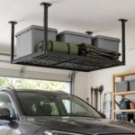 Black overhead ceiling storage rack holding grey boxes above a parked car in a garage