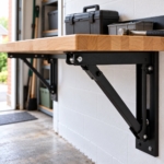 Close-up of a folding steel support bracket under the rubberwood worktop