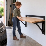 Woman folding the wall-mounted workbench down into its working position